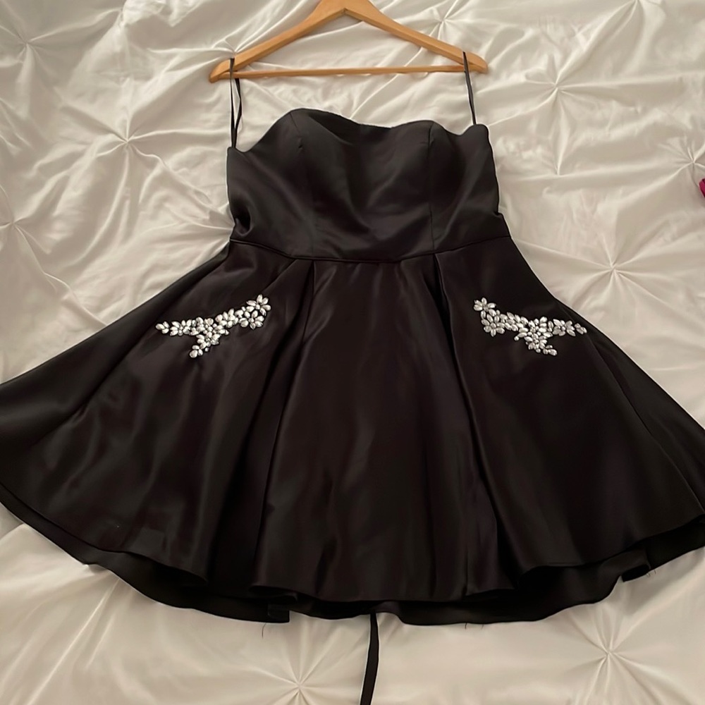 Black strapless dress with sequin embellished pockets